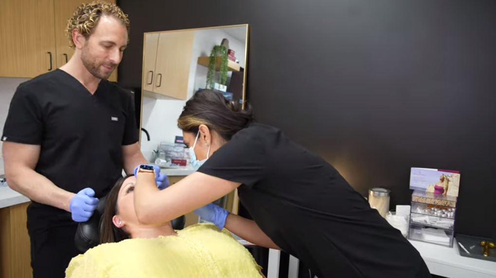 Two Aestheticians Giving Skin Treatment to Female